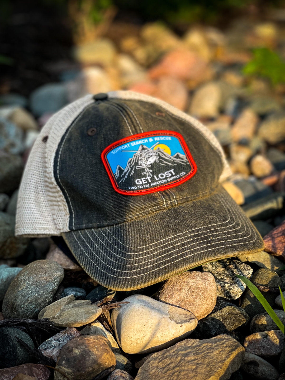 Get Lost V2 distressed black trucker cap with tan mesh and woven Support Search & Rescue patch